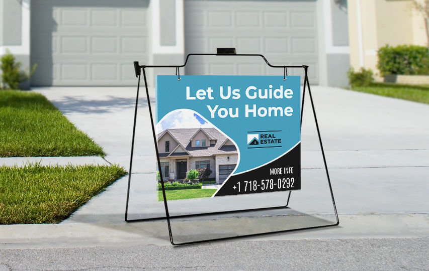 Real estate a frame signs reading Let Us Guide You Home.